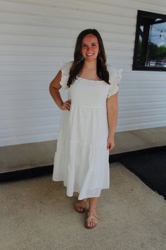 Featuring a square neck, short ruffled sleeves with smocking detail, a tiered silhouette and a textured fabric, this adorable white dress is a must have for summer! Color: White Square neck Short ruffled sleeves with smocking detail Tiered silhouette Midi Length Lined Model is 5'1 and wearing a small. See size guide in images for more details. Measurements are approximate. Fall Candle Decor, Athletic Skirts, Kids Beanies, White Midi, White Square, Summer Color, Ruffled Sleeves, White Midi Dress, Textured Fabric