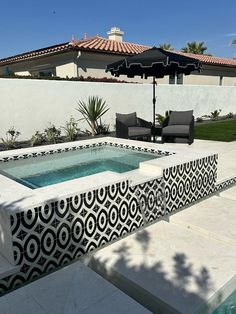 an outdoor swimming pool surrounded by patio furniture