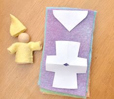 a paper doll next to a piece of felt