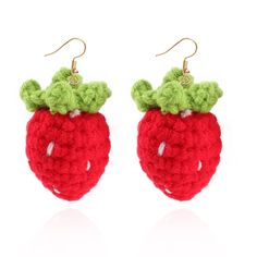 crocheted strawberry earrings with green leaves on top and red fruit in the middle