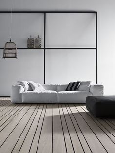 a white couch sitting on top of a wooden floor