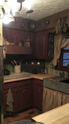 a kitchen with wooden cabinets and lots of clutter