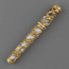 an ornately decorated gold and white pen