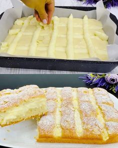 two trays filled with different types of cakes on top of each other, one being cut into slices