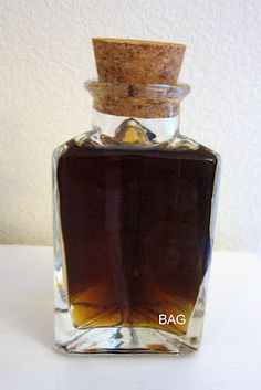 an empty glass bottle with a cork top