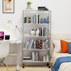 a bedroom with a bed, desk and bookshelf filled with books on it