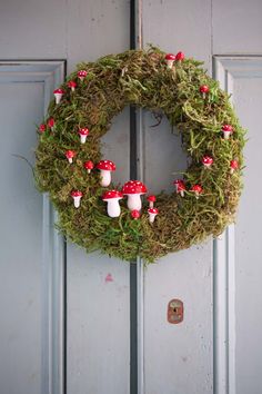 a wreath with mushrooms and moss on it