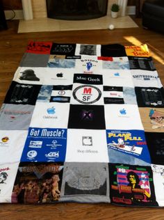 a large blanket covered in many different types of t - shirts on a wooden floor