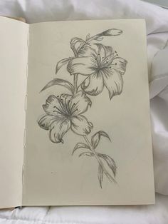 an open book with a drawing of flowers on it