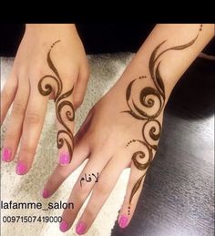 a woman's hands with henna tattoos on them