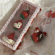 the strawberry keychains have hello kitty on them and are packaged in a package