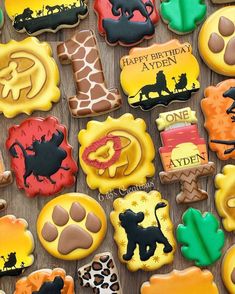 decorated cookies are arranged on a wooden table