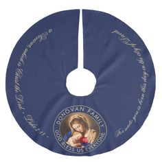 a blue circular ornament with an image of the virgin mary and child jesus