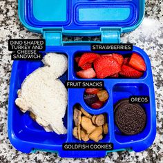 a blue lunch box filled with different foods