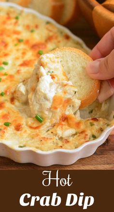 a hand dipping a piece of bread into a casserole dish with text overlay that reads hot crab dip