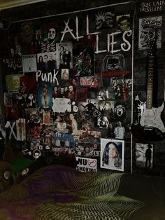 a wall covered in pictures and magnets next to a bed