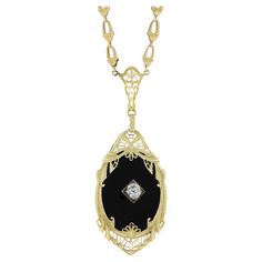 Very Rare to find these necklaces in yellow gold! Most were made in white and platinum. The yellow gold and black onyx combined with the masterful Art Deco Workmanship is truly something special! Enjoy! --Stone(s):-- (1) Natural Genuine Black Onyx - Oval Cut - Prong Set - Rich Black Color - 24x18mm (approx.) (1) Natural Genuine Diamond - Old Mine Cut - Prong Set - 0.22ct (approx.) Total Carat Weight: 0.22 (approx.) Material: Solid 14k Yellow Gold Weight: 8.8 Grams Chain Type: Fancy Link Chain Ch Art Deco White Gold Necklace With Gemstone, Art Deco White Gold Gemstone Necklace, White Gold Art Deco Gemstone Necklace, Art Deco White Gold Oval Necklace, Black 14k Gold Engraved Jewelry, Art Deco Gemstone Necklace For Anniversary, Art Deco Pendant Necklace For Formal Occasions, Engraved 14k Black Gold Jewelry, Engraved Black 14k Gold Jewelry