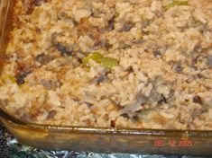 a casserole dish with meat and vegetables in it sitting on the stove top