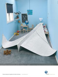 a child's room with a large white tent on the floor