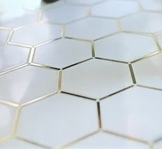 a close up view of some white hexagonal tiles