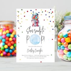 a jar filled with candy next to a card