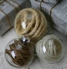 three balls of twine are sitting next to each other on top of wrapped presents