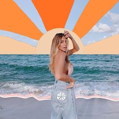 a woman standing on top of a beach next to the ocean with an orange sun above her