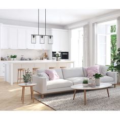 a living room filled with white furniture and lots of windows next to a counter top