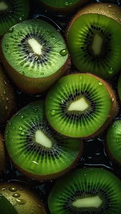 sliced kiwi fruit with water droplets on them