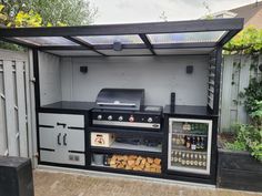 an outdoor bbq grill with lots of food on it's shelves and doors