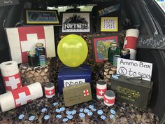 a trunk filled with lots of different items and signs on the back of a car