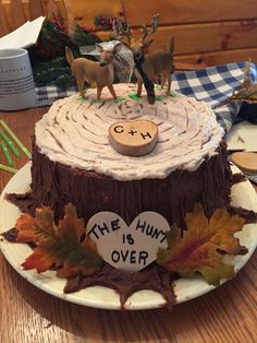 a cake with frosting on it sitting on top of a table next to other decorations