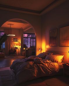 a dimly lit bedroom with an arch leading into the living room and dining area at night