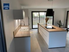 a modern kitchen with an island and sink