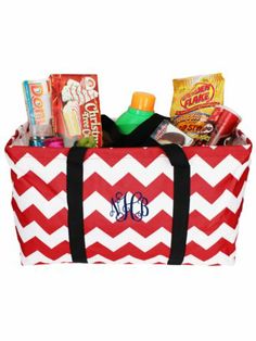 a red and white chevroned bag with monogrammed items in the bottom