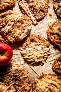 cookies and an apple on a table with icing drizzled over them