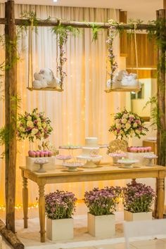 a table with cupcakes and flowers on it