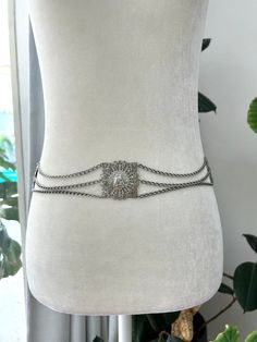 Unique, silver toned, chain belt with filagree tiles with Roman head coins.  Belt is in overall excellent vintage condition with no notable flaws. Belt closes with a hook closure. No designers mark or label.  Measurements  Length 40in/101.5cm Width 1.75in/4.5cm *Please keep in mind that unless otherwise noted, all items in my shop are used or previously owned, normal wear and tear is expected, flaws that are noted are range from major to minor, things like a missing stitch here or there my not b Vintage Silver Adjustable Chain Belt, Silver Metal Waist Chain With Chain Strap, Adjustable Silver Vintage Chain Belt, Elegant Silver Metal Chain Belt, Vintage Metal Chain Belt With Adjustable Chain, Formal Silver Chain Belt, Vintage Silver Chain Belt For Party, Silver Metal Waist Chain Belt, Silver Elegant Chain Link Waist Chain