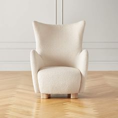 a white chair sitting on top of a hard wood floor