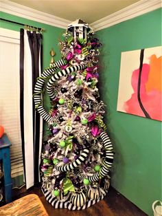 a christmas tree decorated with black, white and green ornaments