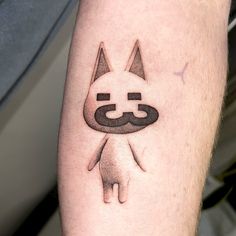 a person with a cat tattoo on their arm and leg, showing it's face