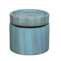 a blue ceramic container with a lid on it's side, sitting in front of a white background