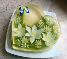 the cake is decorated with flowers and butterflies