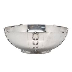 a silver bowl on a white background with chains around the rim and bottom part of the bowl