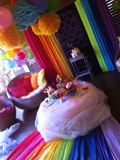 a room filled with lots of colorful balloons and streamers