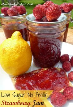 strawberry jam in jars with lemon and raspberry jam on the side for garnish