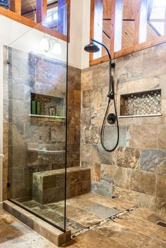 a walk in shower sitting inside of a bathroom