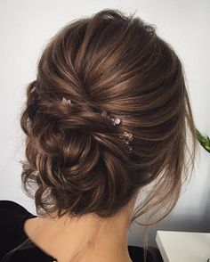 the back of a woman's head with hair pins in her hair