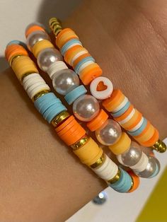 the bracelets are stacked on top of each other and have different colored beads in them