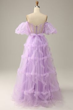 Feel like a fairy tale princess in this breathtaking lavender tulle gown! Show off your style with its off-the-shoulder ball sleeves, sheer corset bodice, and ruffle embellishment. A zip-up back and included sash add an extra touch of elegance. Make your dreams come true! Tullematerial Lavender Color Off the Shoulder with ball sleeves Sheer corset bodice Ruffle embellishment Zipupback Comes with sash Fully lined Built-in bra Care: hand wash only Prom Dresses Rapunzel, Disney Princess Prom Dresses Rapunzel, Purple Gown Elegant, Disney Princess Prom Dresses, Lavender Prom Dresses, Wedding Dress Backs, Sweep Train Prom Dress, Purple Tulle, A Line Prom Dress